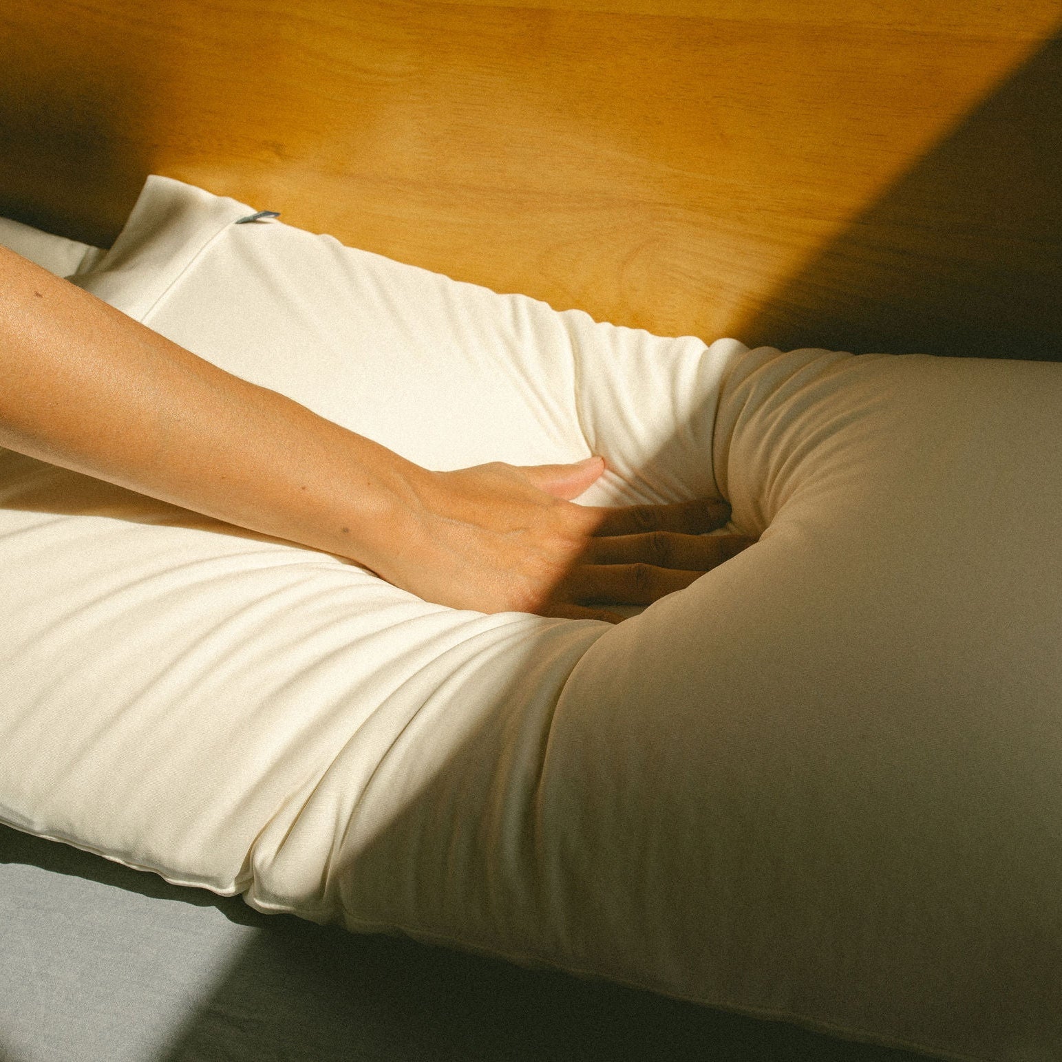 hand pressing down into a pillow